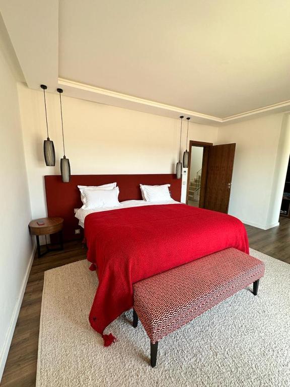 a bedroom with a large bed with a red blanket at Les Palms De L’Atlas in Marrakesh