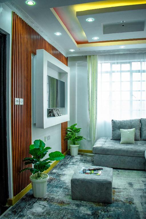 a living room with a couch and a tv at Urban Elegance in Nairobi