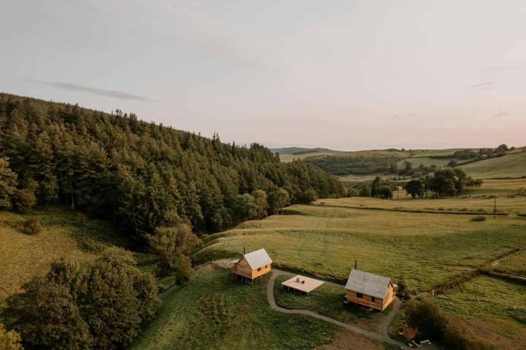 an aerial view of a field with trees and buildings at Woolly Wood Cabins - Bryn in Llandrindod Wells