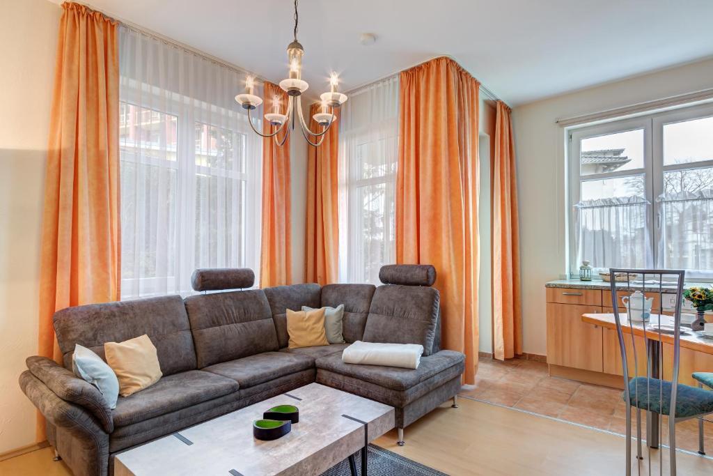 een woonkamer met een bank en een tafel bij Villa Sabinium in Heringsdorf