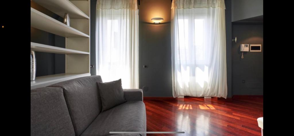 a living room with a couch and a window at Corso Garibaldi Suite in Milan