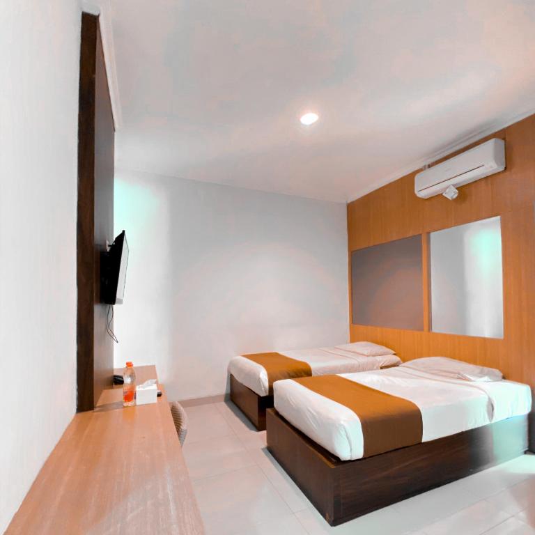 Postel nebo postele na pokoji v ubytování DINASTY STYLE HOTEL SOLO