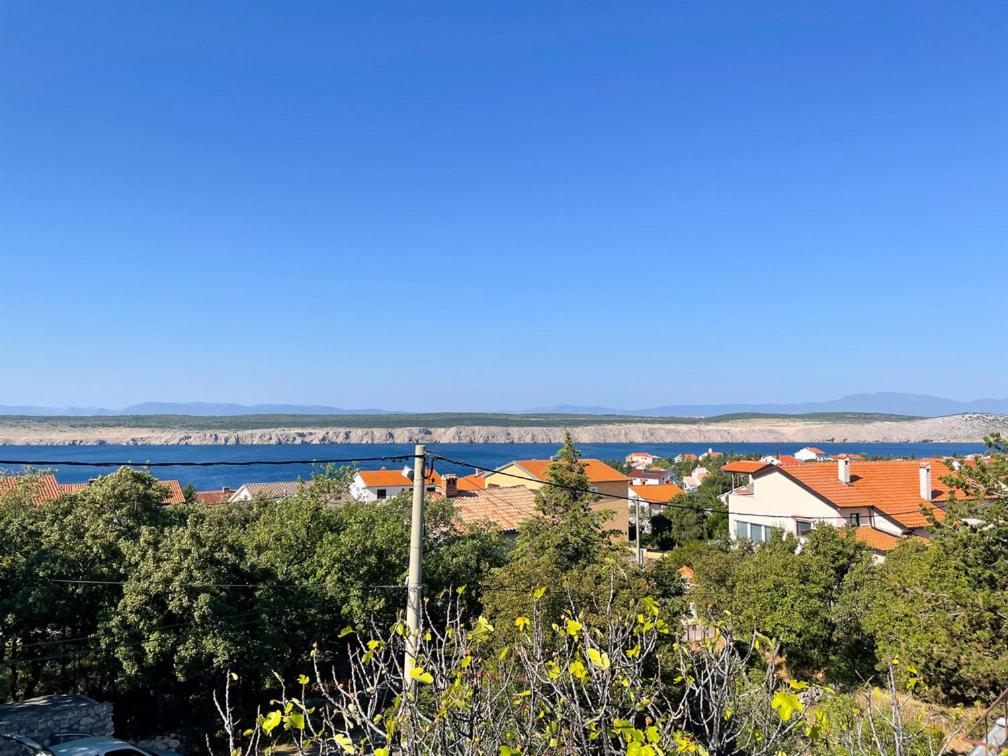 a view of a town with a river and houses at Apartmani Ružić in Jadranovo