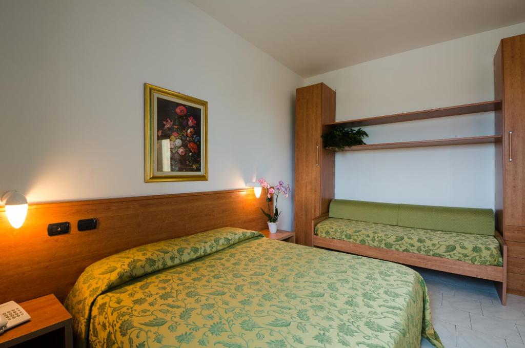 a hotel room with a bed and a window at Hotel Luna Blu in Casumaro