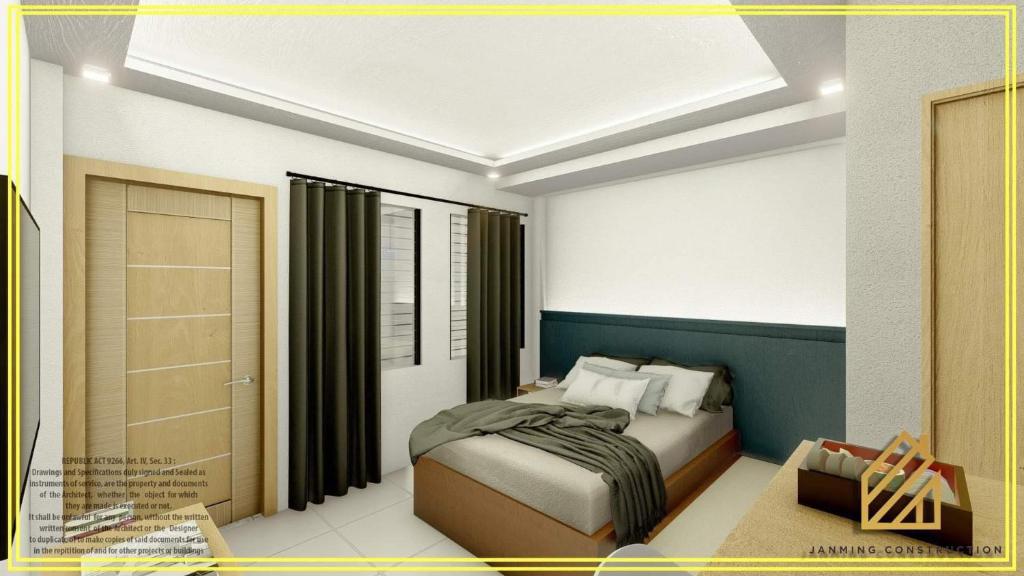 a bedroom with a bed in a room at JP Suites & Residences in Tayabas