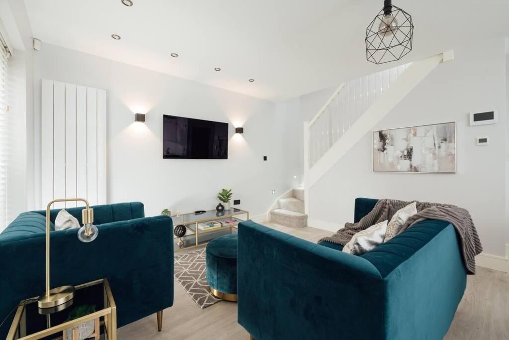 a living room with two blue couches and a tv at Inviting 2 Bedroom House in Dorking in Dorking