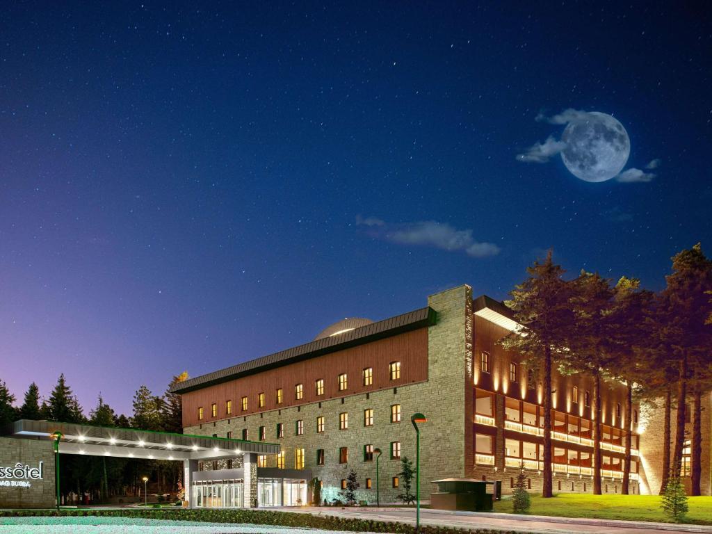 a large brick building with a moon in the sky at Swissotel Uludag Bursa in Bursa