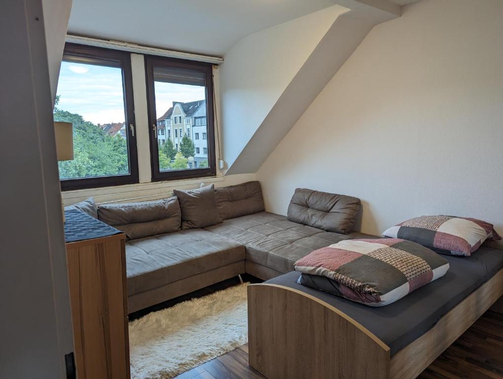 a living room with a couch and a large window at Gästehaus Gröpelingen in Bremen