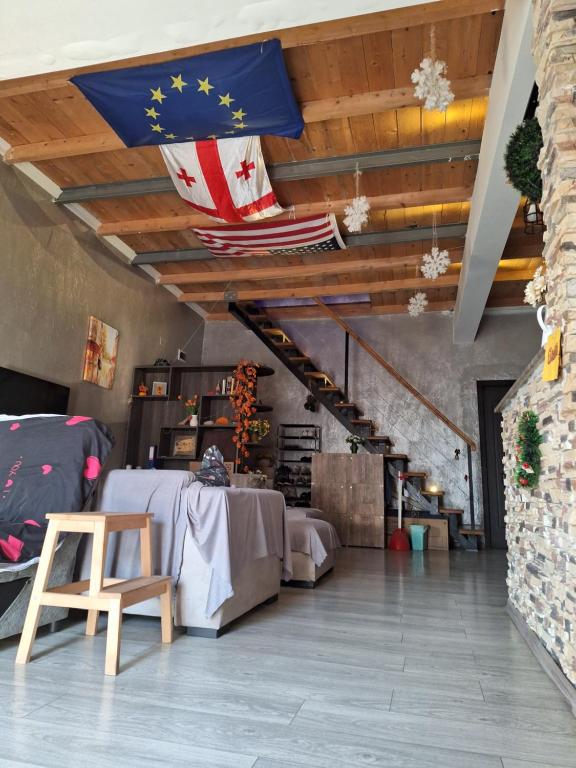 バトゥミにあるChase Dream Hostel追梦空间の天井にテーブルと旗を掲げた部屋