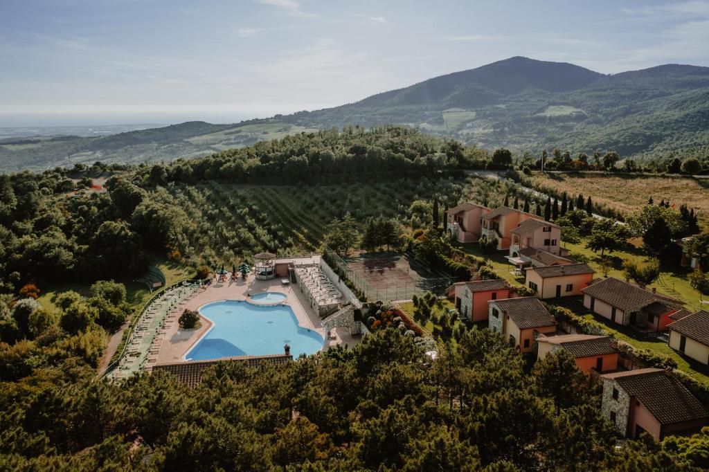 an aerial view of a resort with a swimming pool at Borgo San Pecoraio Resort in Riparbella