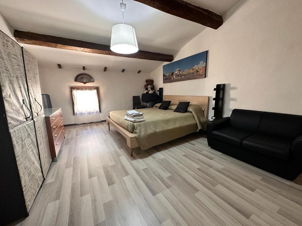 1 dormitorio con 1 cama y 1 sofá en una habitación en Karivi - Poma en Florencia
