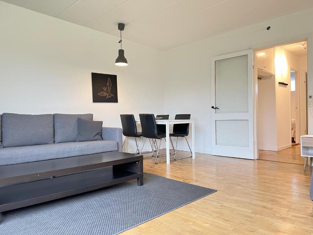 een woonkamer met een bank en een tafel bij One Bedroom Apartment In Rdovre, Trnvej 41b, in Rødovre