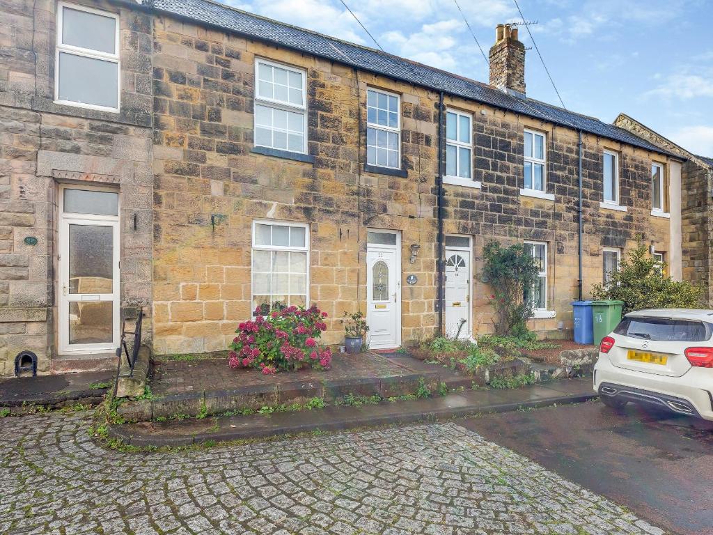 a brick house with a car parked in front of it at Hillcroft in Alnwick