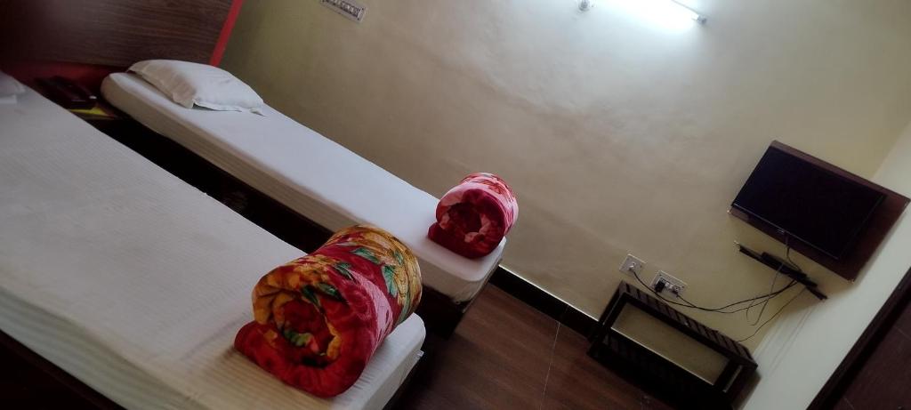 a room with two beds with pillows on them at Hotel Shiva Krishna(Unit of Nandan Udyam Pvt Ltd) in Patna