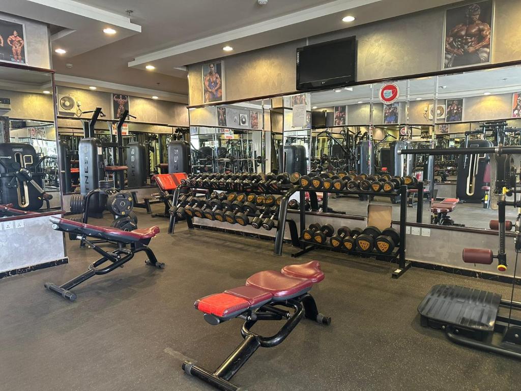 a gym with lots of exercise equipment in a room at Makarim Palm Hotel in Rabigh