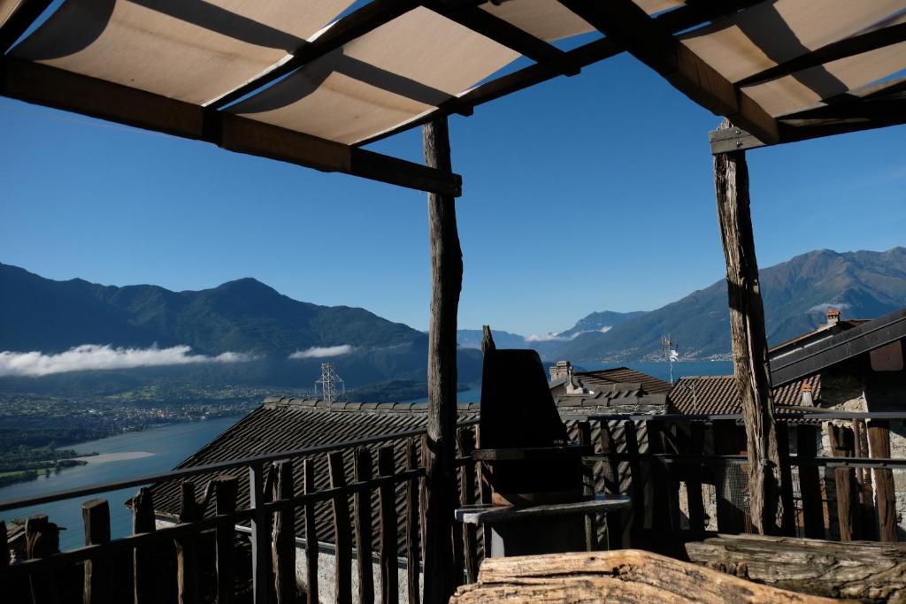 a balcony with a view of a river and mountains at Appartamenti Montemezzo Le Case in Pietra in Sorico