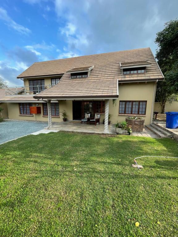 a house with a lawn in front of it at OAK HOUSE, Entire holiday home, Self catering, fully equipped, double storey, 3 bedroom, 2 bathroom, outside entertainment, Braai area, 300sqm home in Hillcrest