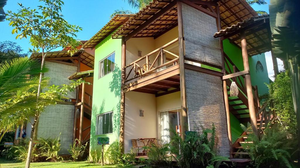 a building with a balcony on the side of it at PachaMama Flats - Taipu de Fora in Barra Grande
