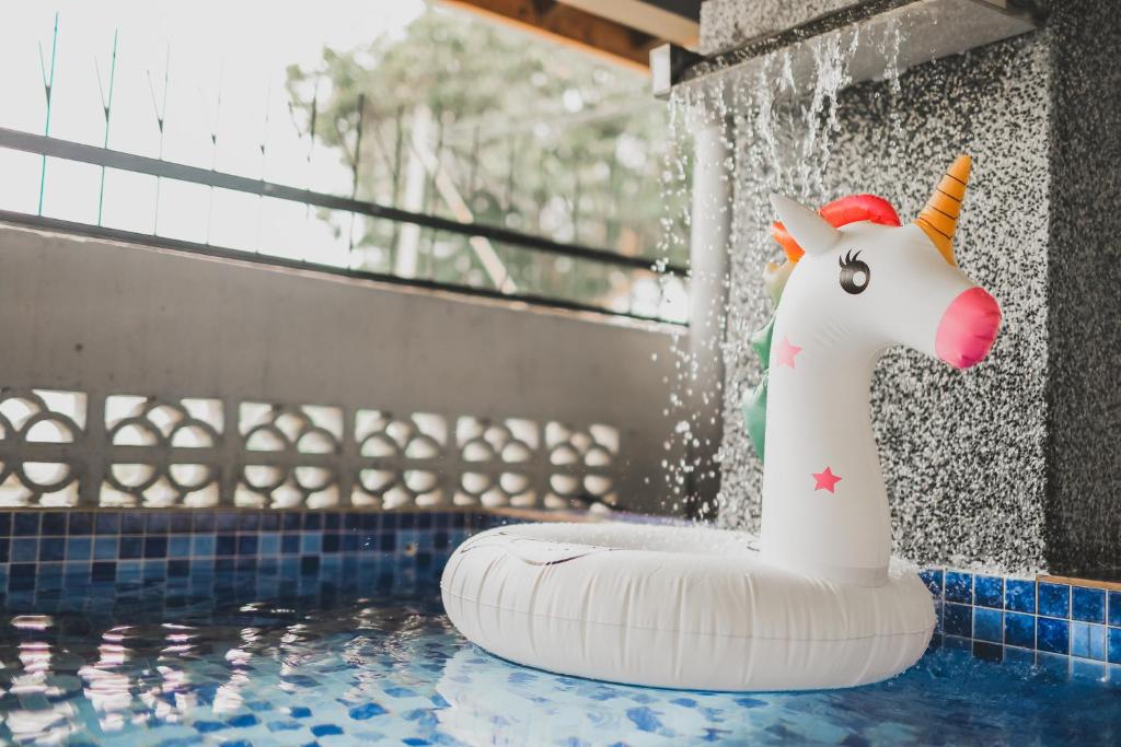 a inflatable unicorn toy in a swimming pool at PD Corner Lot 5R3BR 15pax Pool Homestay 5min to Beach in Port Dickson
