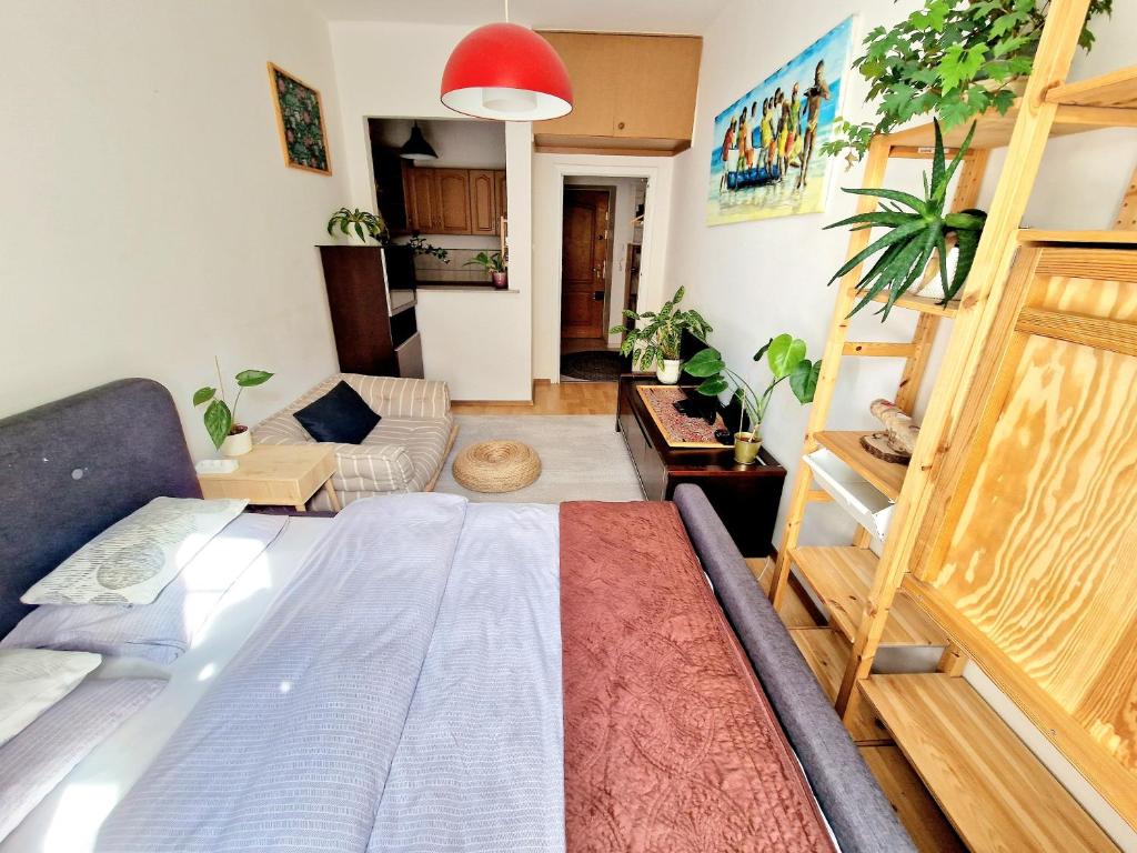 a bedroom with a bed and a living room at INNY Apartament Rynek Opole in Opole