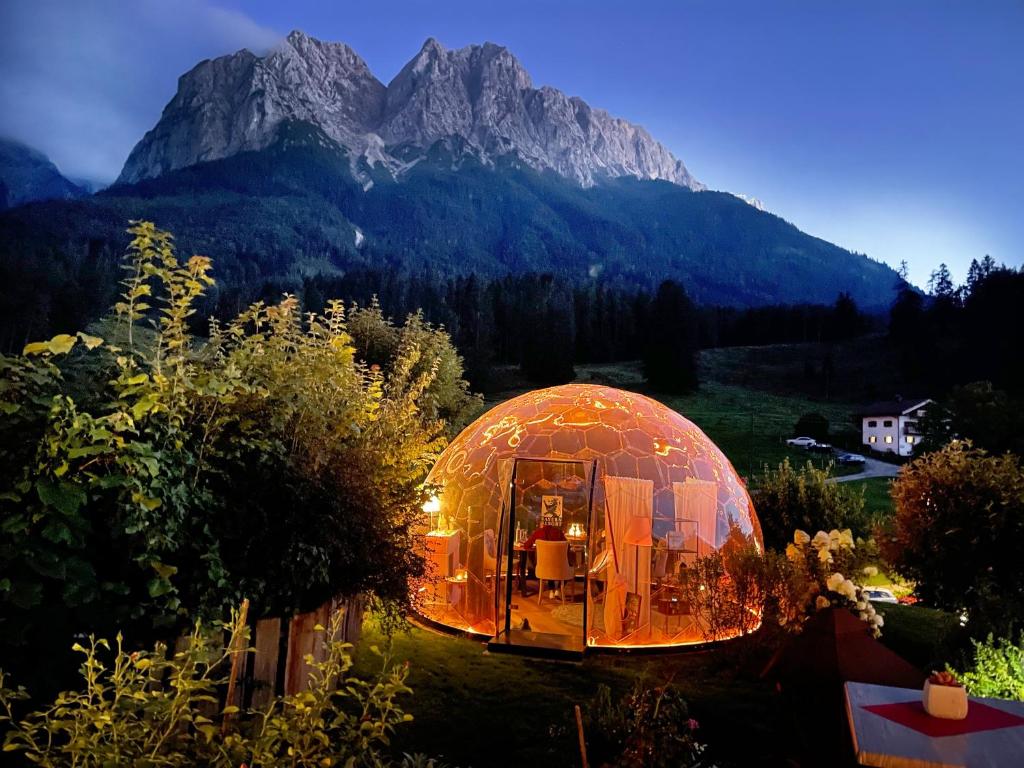 a dome tent with a mountain in the background at Bayern Resort Hotel (Adults only) in Grainau