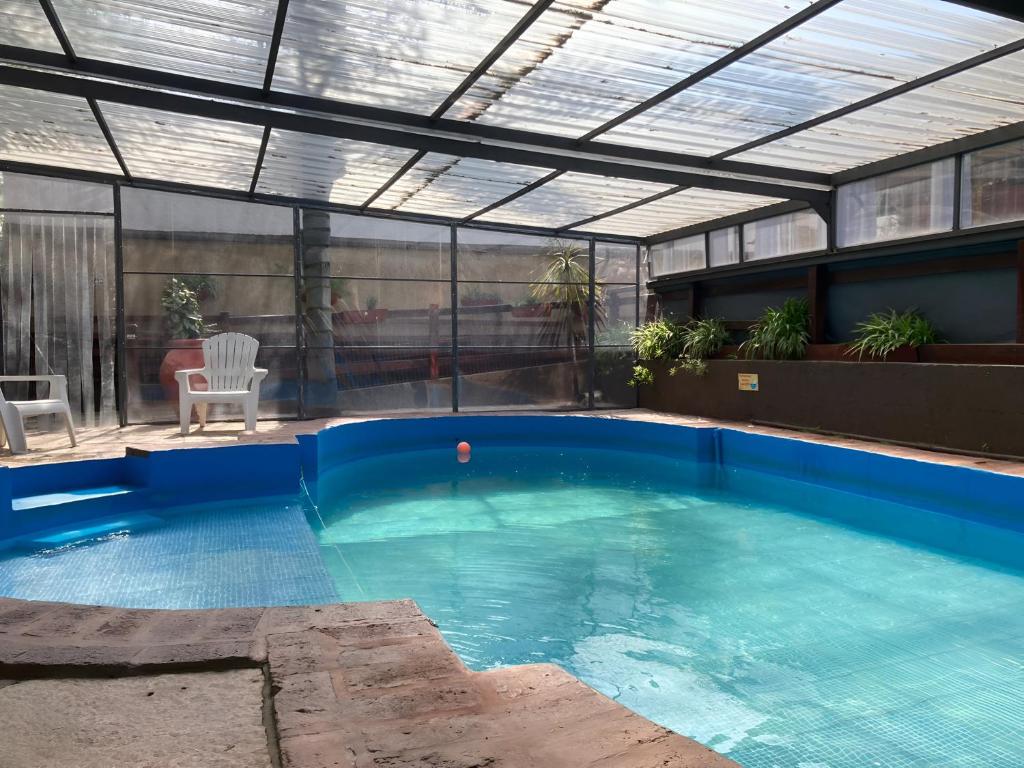 a large swimming pool with a roof at Carlos Paz Departamentos in Villa Carlos Paz