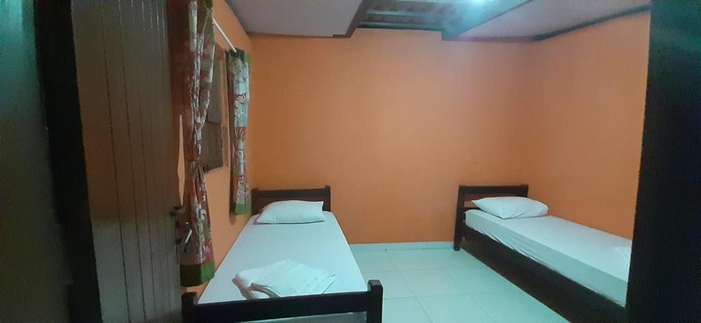 Postel nebo postele na pokoji v ubytování ROSÁRIO TEMPORADA Hostel