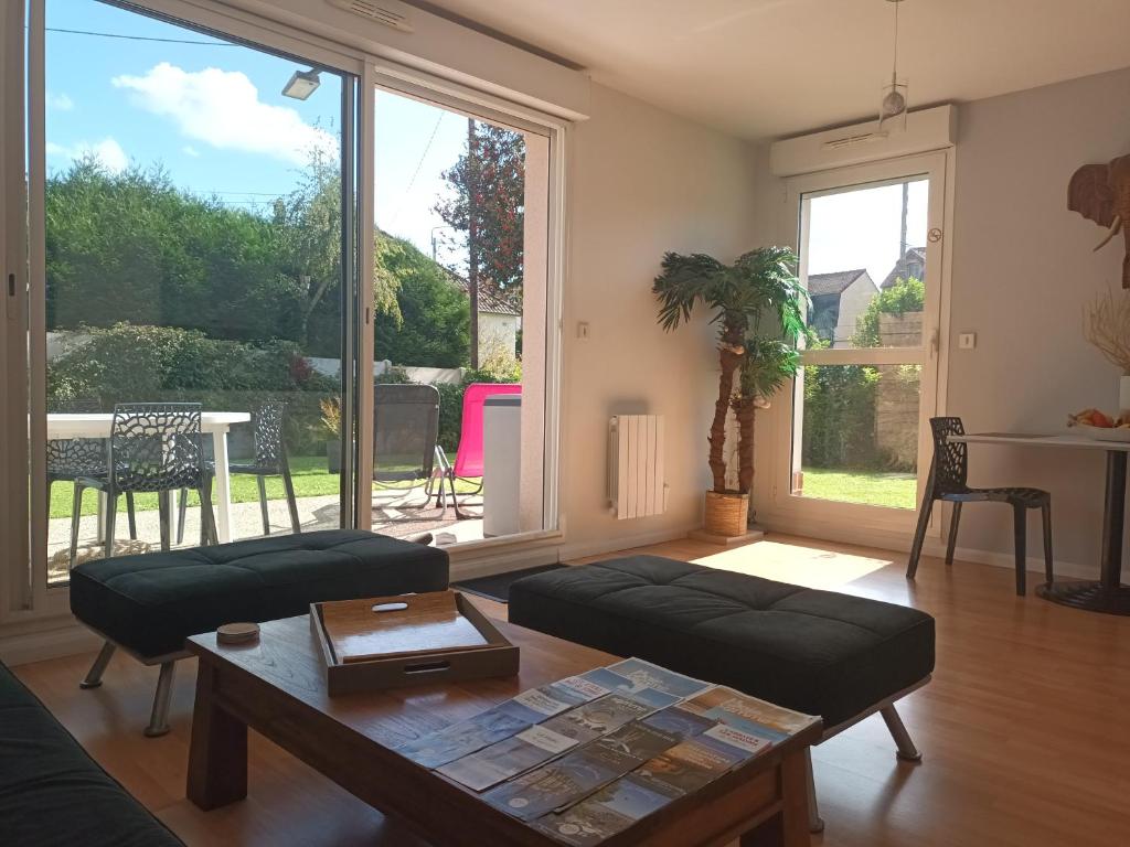 a living room with a couch and a table at résidence la clairière aux portes de la baie de Somme in Abbeville