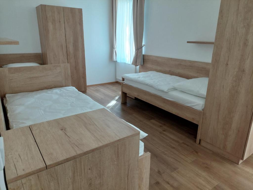 Postel nebo postele na pokoji v ubytování Penzion ČESKÁ FARMA