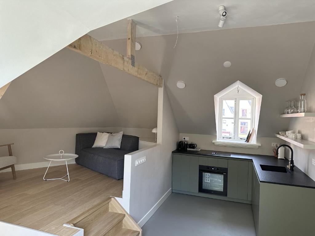 a living room with a couch in a loft at Luxe Loft in Historisch Pand in Walstraat Deventer in Deventer
