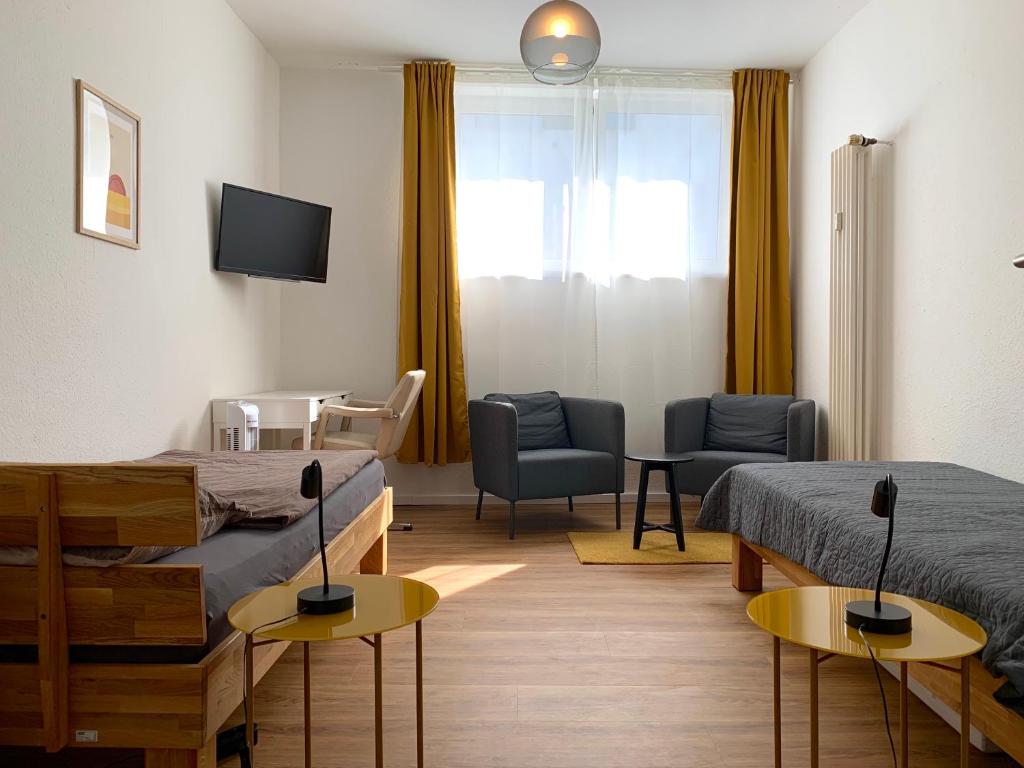 a hospital room with two beds and a tv at Alles komplett: Zwei Schlafzimmer, große Küche, eigenes Bad in Cologne