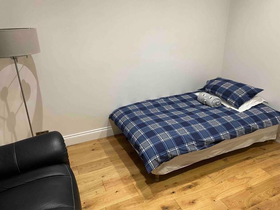 a bedroom with a bed with a pillow and a chair at Top Floor Flat - Glasgow West End - Partick in Glasgow