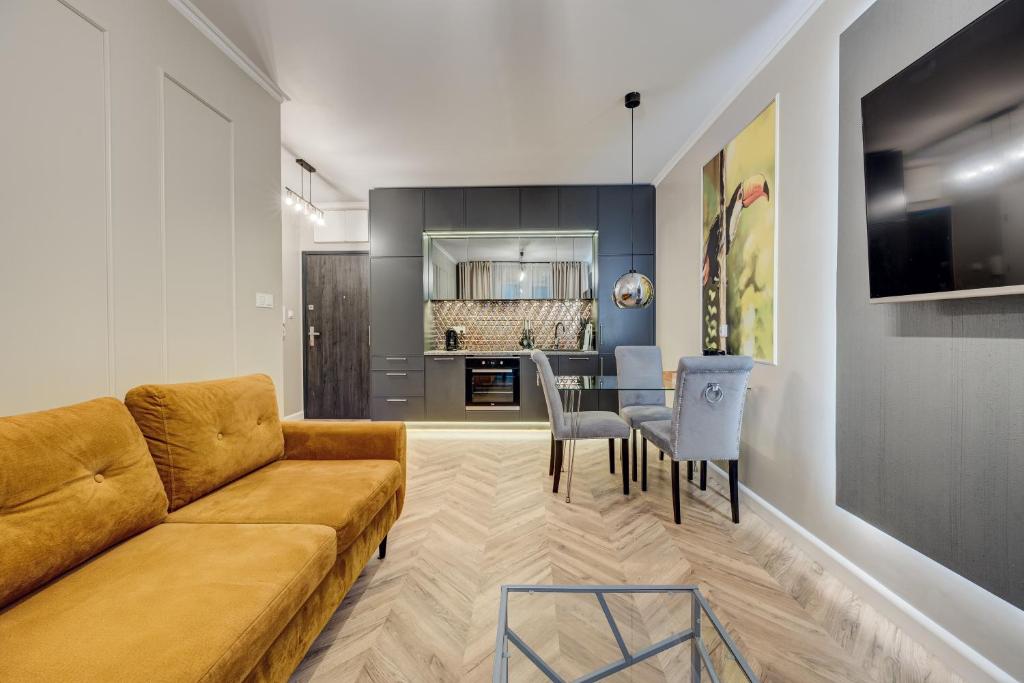 a living room with a couch and a table at Allure NOVA Aparthotel in Szczecin