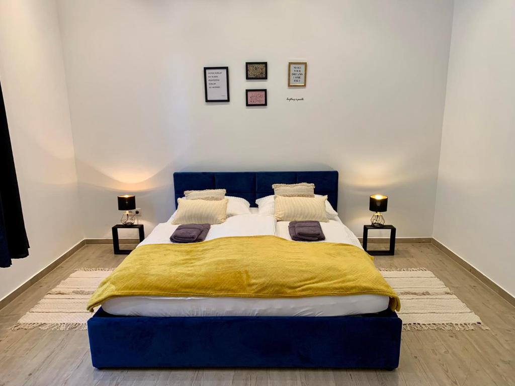 a bedroom with a blue bed with a yellow blanket at Luxspace Apartment Hagen in Hagen