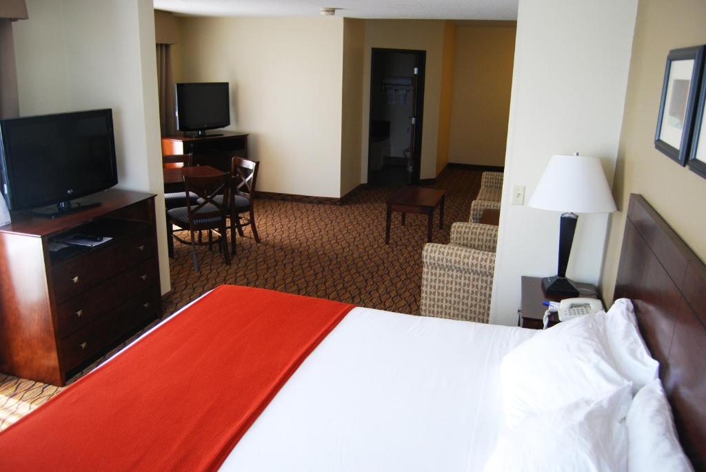 a hotel room with a bed and a flat screen tv at Holiday Inn Express & Suites Superior, an IHG Hotel in Superior