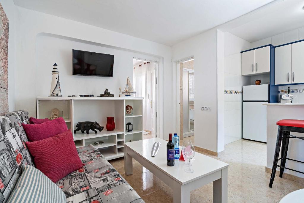 a living room with a couch and a table at Apartamentos Dulcemar Frente al Mar con zona SPA in San José