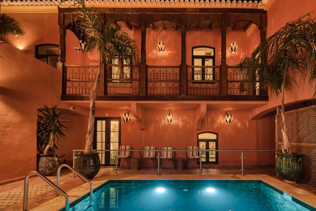 an indoor pool in a house with a balcony at Casa Riad Yasmin in Silves