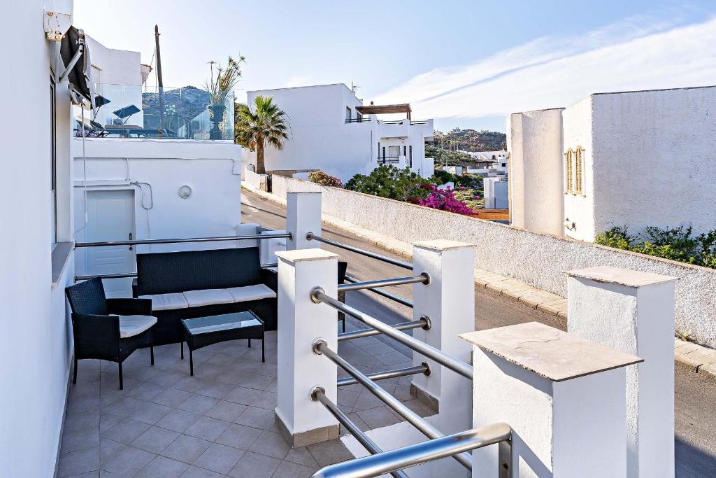 a balcony with a table and chairs on a building at Apartamentos Dulcemar Frente al Mar con zona SPA in San José