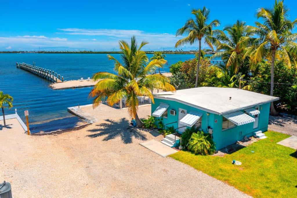 an aerial view of a blue house on the beach at Waterfront Cozy Cottage with Boat Ramp & Dock in Little Torch Key
