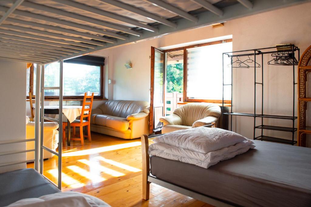 a bedroom with a bunk bed and a living room at Biały Domek in Międzybrodzie Bialskie
