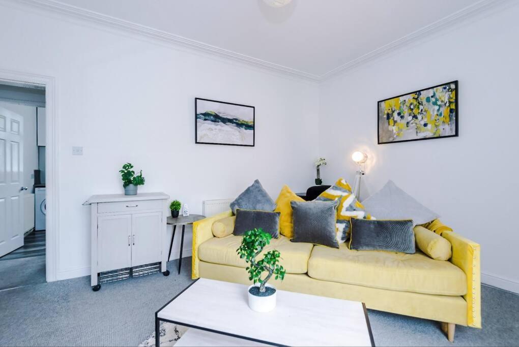a living room with a yellow couch and a table at Long term offers Message for prices Sleeps 6 Adults, Contractors, Relocators, Travellers in Halifax