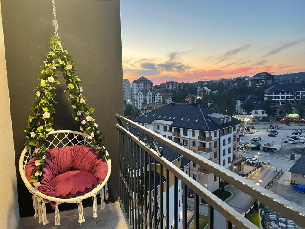 a room with a christmas tree on a balcony at Apartman sa ljuljaskom in Zlatibor
