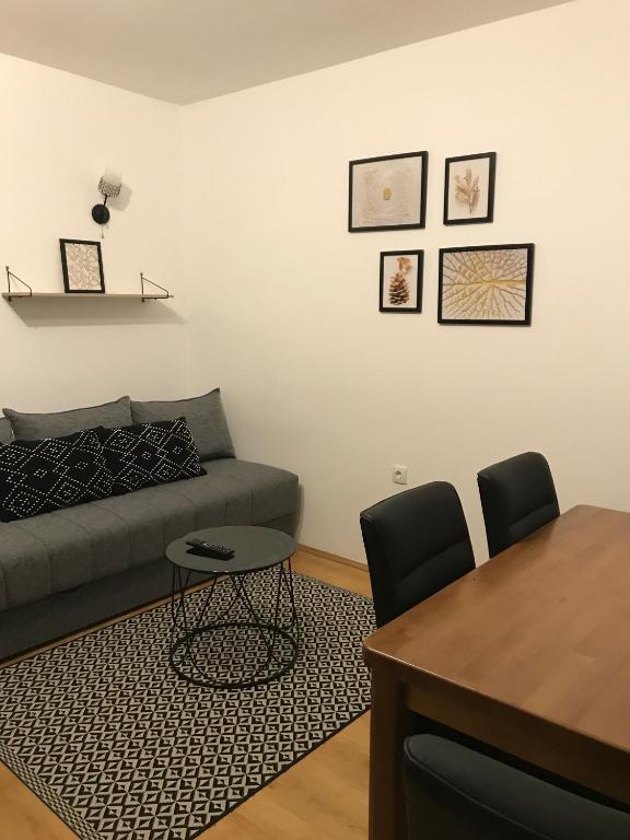 a living room with a couch and a table at Planinski Raj - Bela Reka Gondola in Brzeće