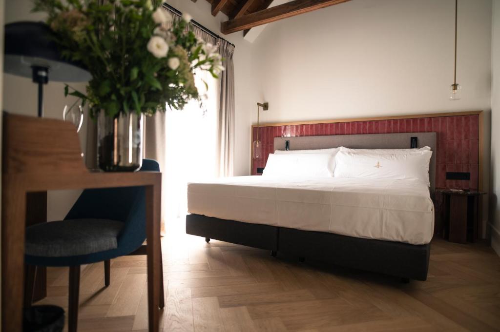 Postel nebo postele na pokoji v ubytování Legado Magdalena Hotel