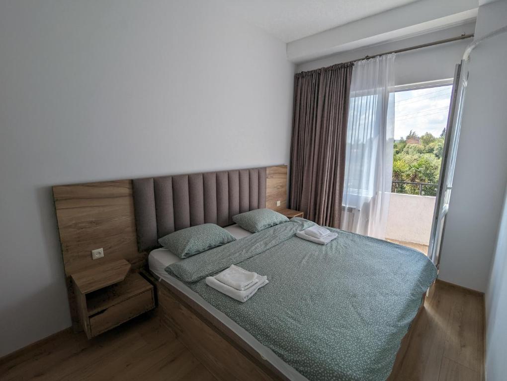 a small bedroom with a bed with a window at Brand new apartment in Kutaisi in Kutaisi