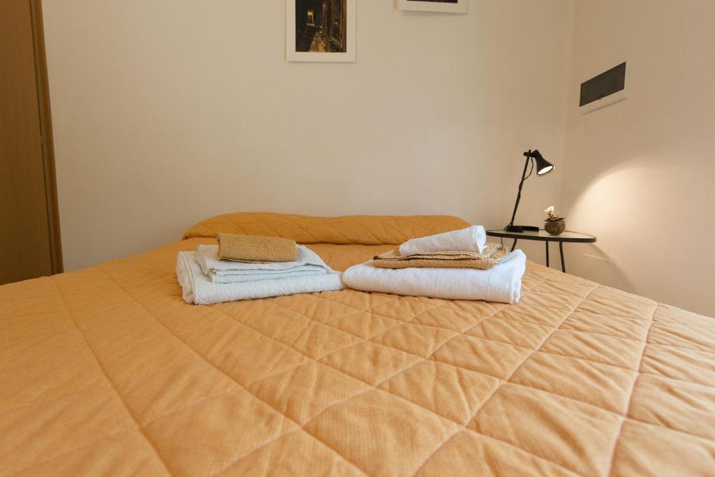 a bedroom with a large bed with two towels on it at Affittacamere Donati Nada in Carmignano