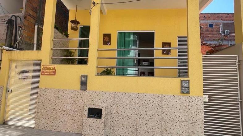 a yellow building with a door and a window at Residencial Morro de São Paulo in Morro de São Paulo