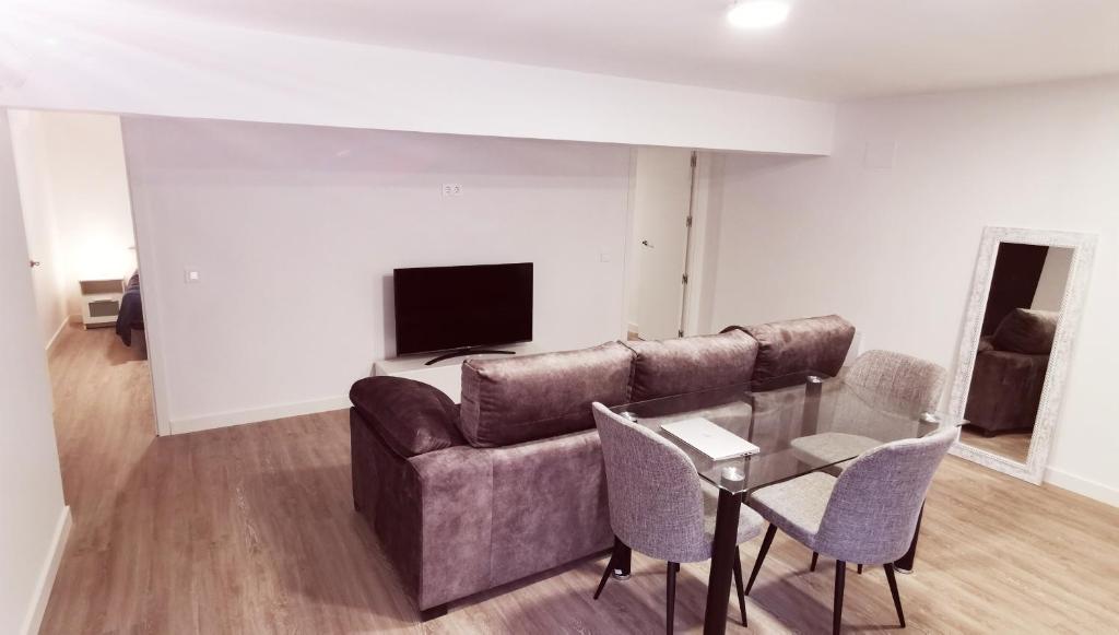 een woonkamer met een bank en een tafel bij Piso de lujo 2 habitaciones in Las Rozas de Madrid