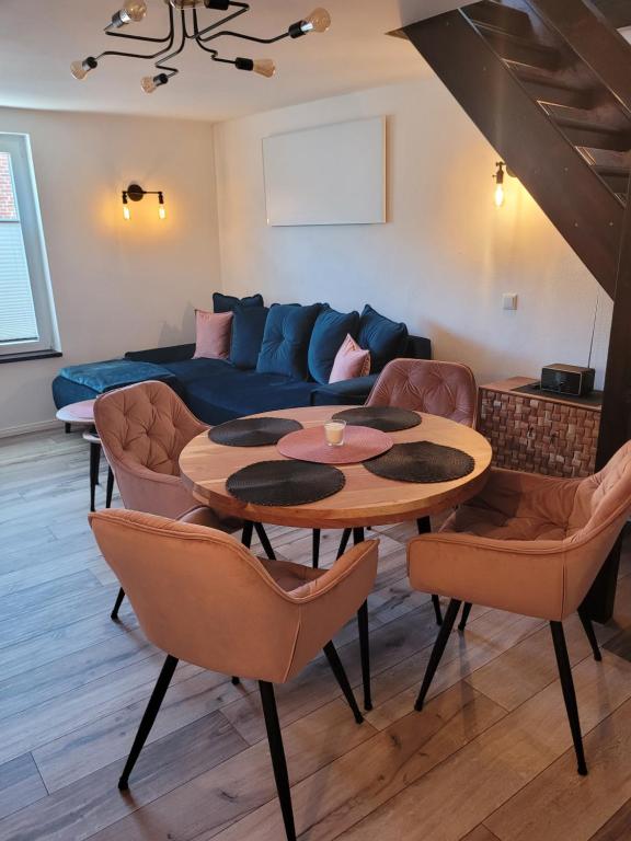 a living room with a table and chairs and a couch at FeWo Todeskino ``Altstadtflair`` in Heiligenhafen in Heiligenhafen