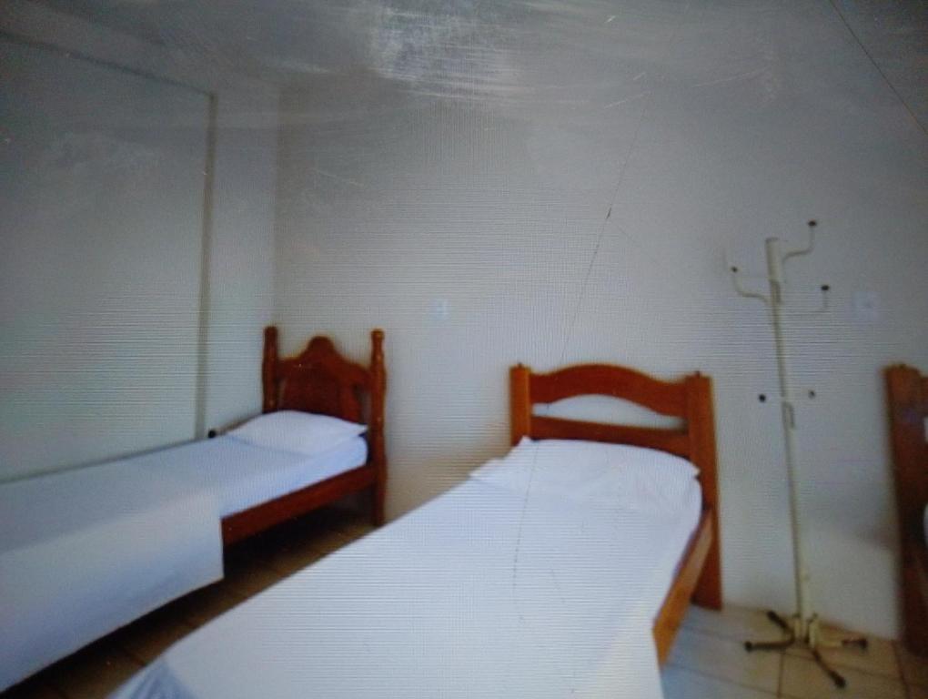 a room with two beds in a room at Hotelcoxipo in Cuiabá